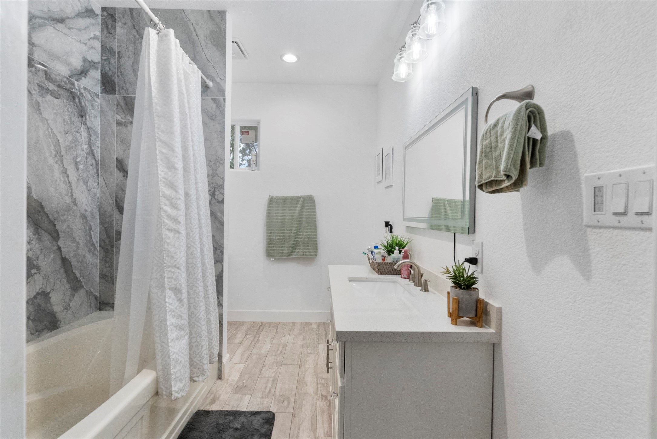 21502 Flint Trail Porter, TX 77365 - Photo 22 of 38 a bathroom with a sink and mirror with bathtub