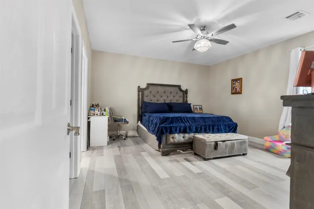 a bedroom with a bed and a chandelier