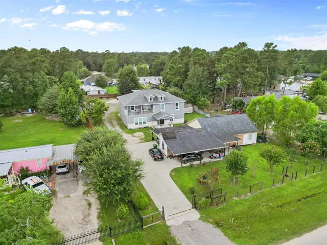 an aerial view of a house with garden space and street view