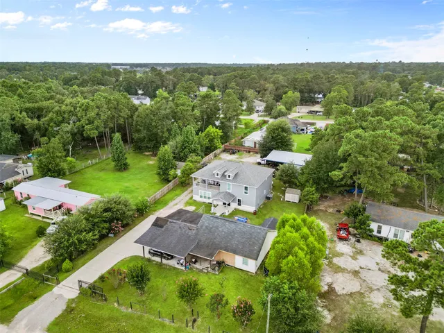 an aerial view of a house with yard swimming pool and outdoor seating