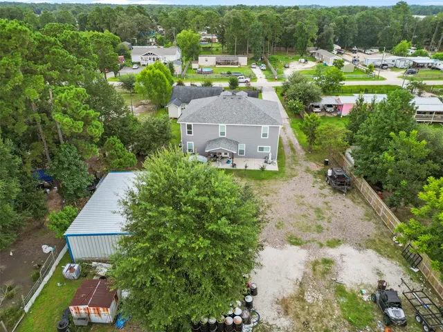 an aerial view of house with yard and outdoor seating