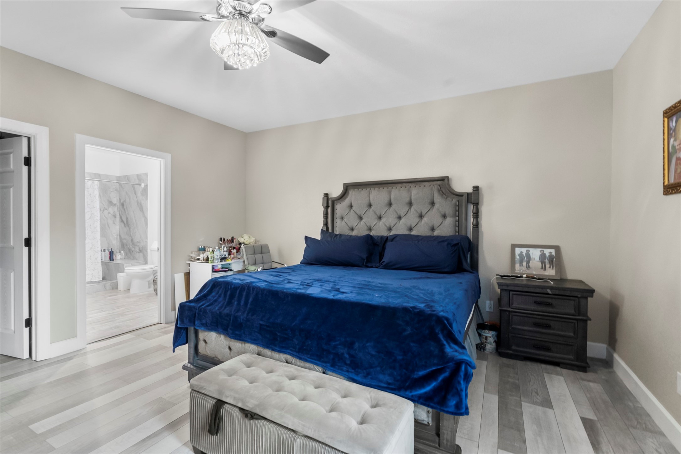 21502 Flint Trail Porter, TX 77365 - Photo 4 of 38 a bedroom with a bed and a chandelier