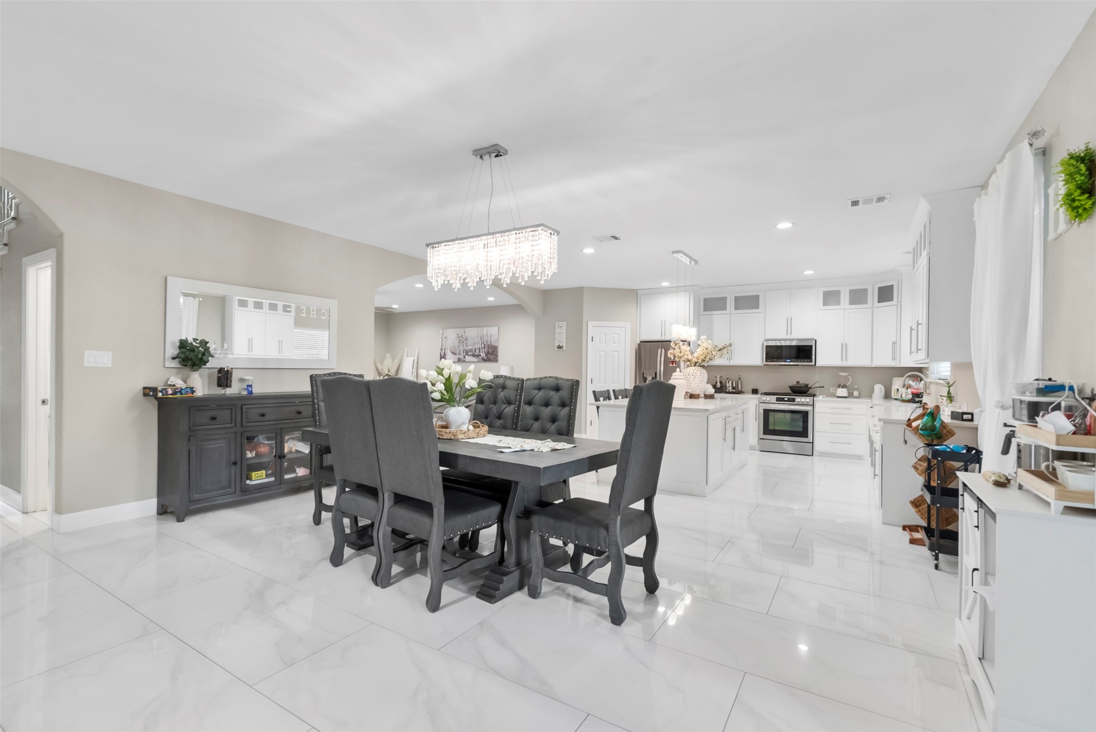 21502 Flint Trail Porter, TX 77365 - Photo 8 of 38 a view of a dining room and livingroom with furniture a rug a potted plant and a painting