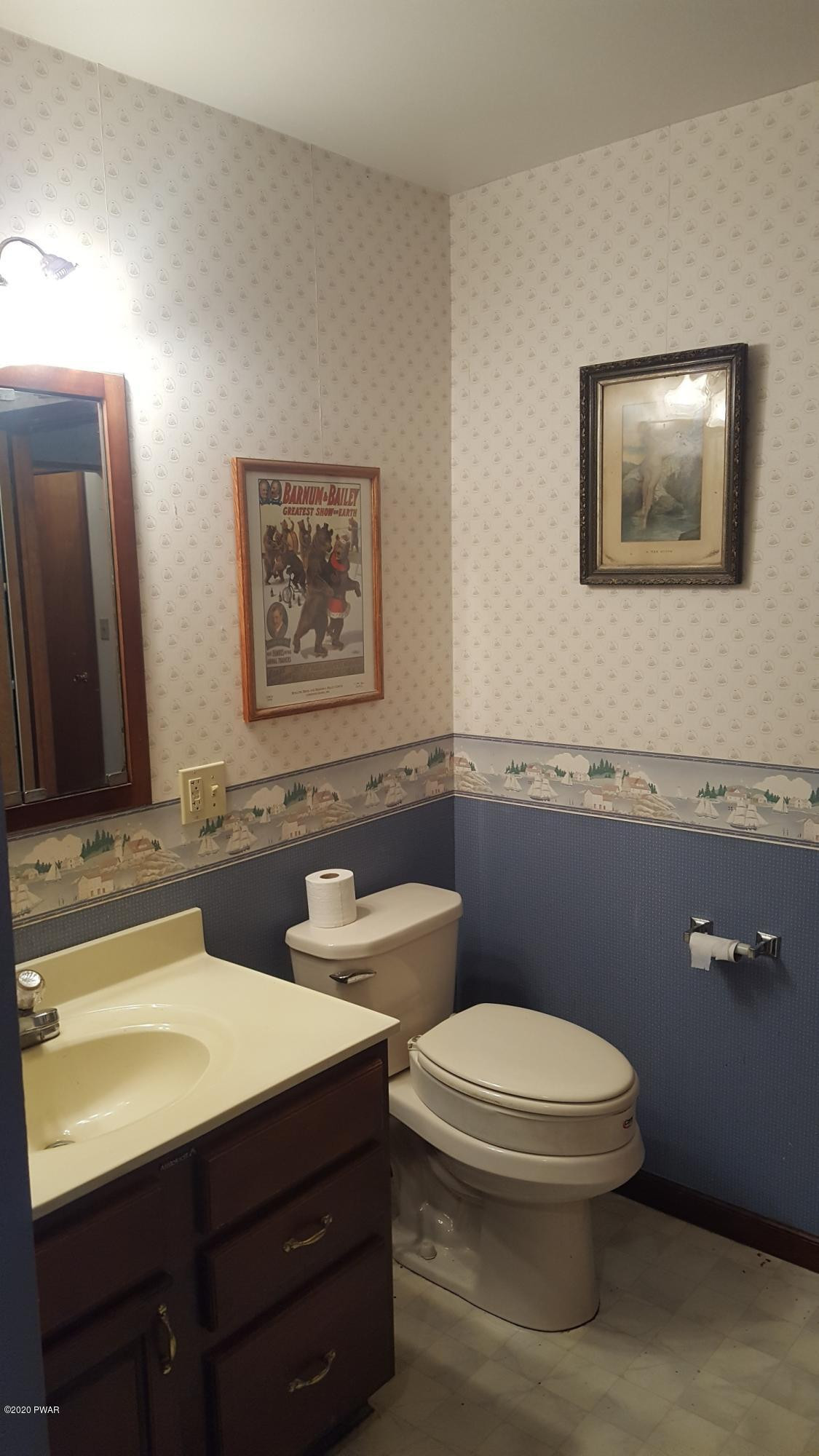 554 St Tikhons Road Waymart, PA 18472 - Photo 6 of 29 a bathroom with a toilet sink and mirror