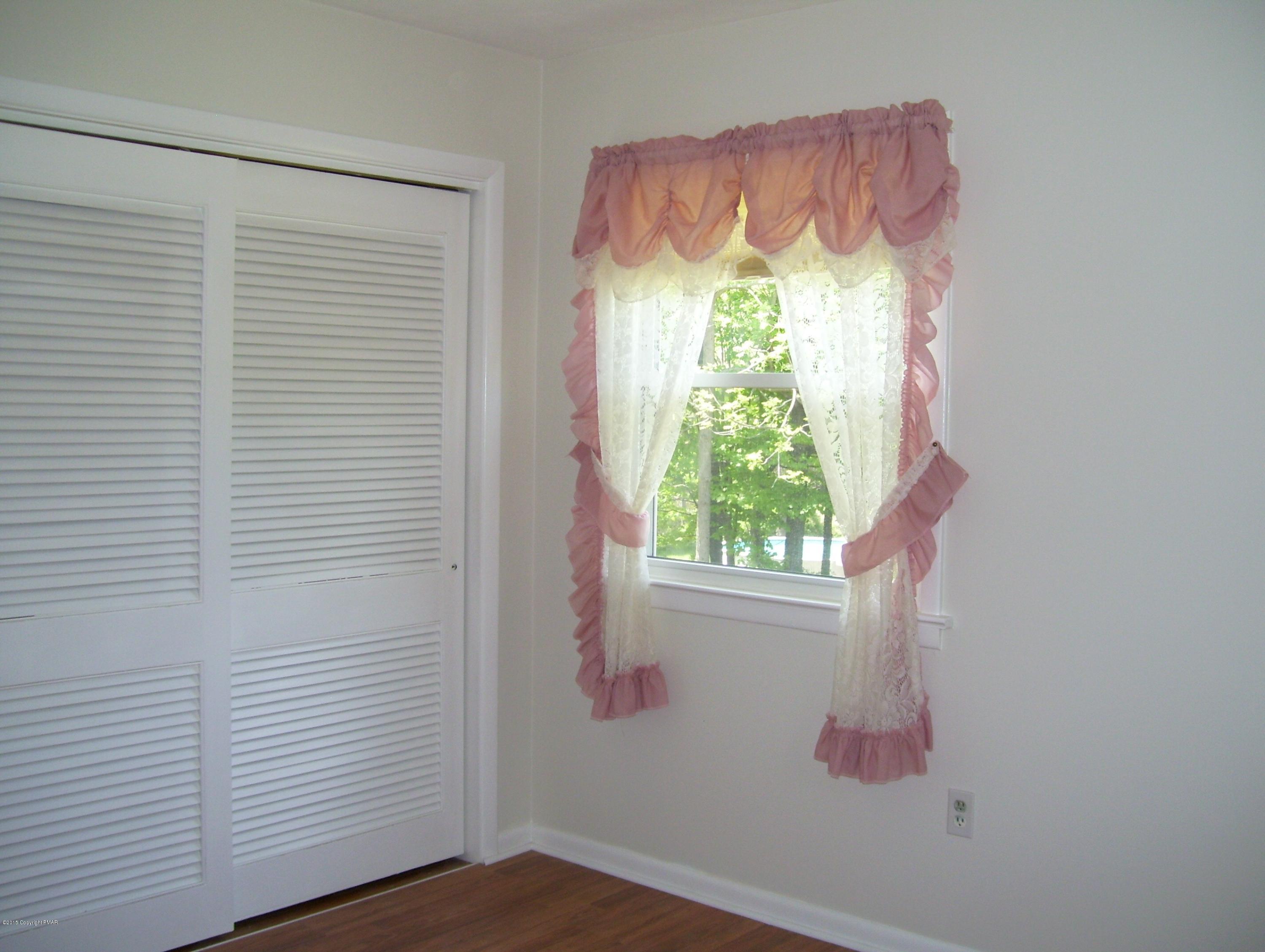2610 Brookdale Road Scotrun, PA 18355 - Photo 14 of 37 a bathroom with a window and a chandelier