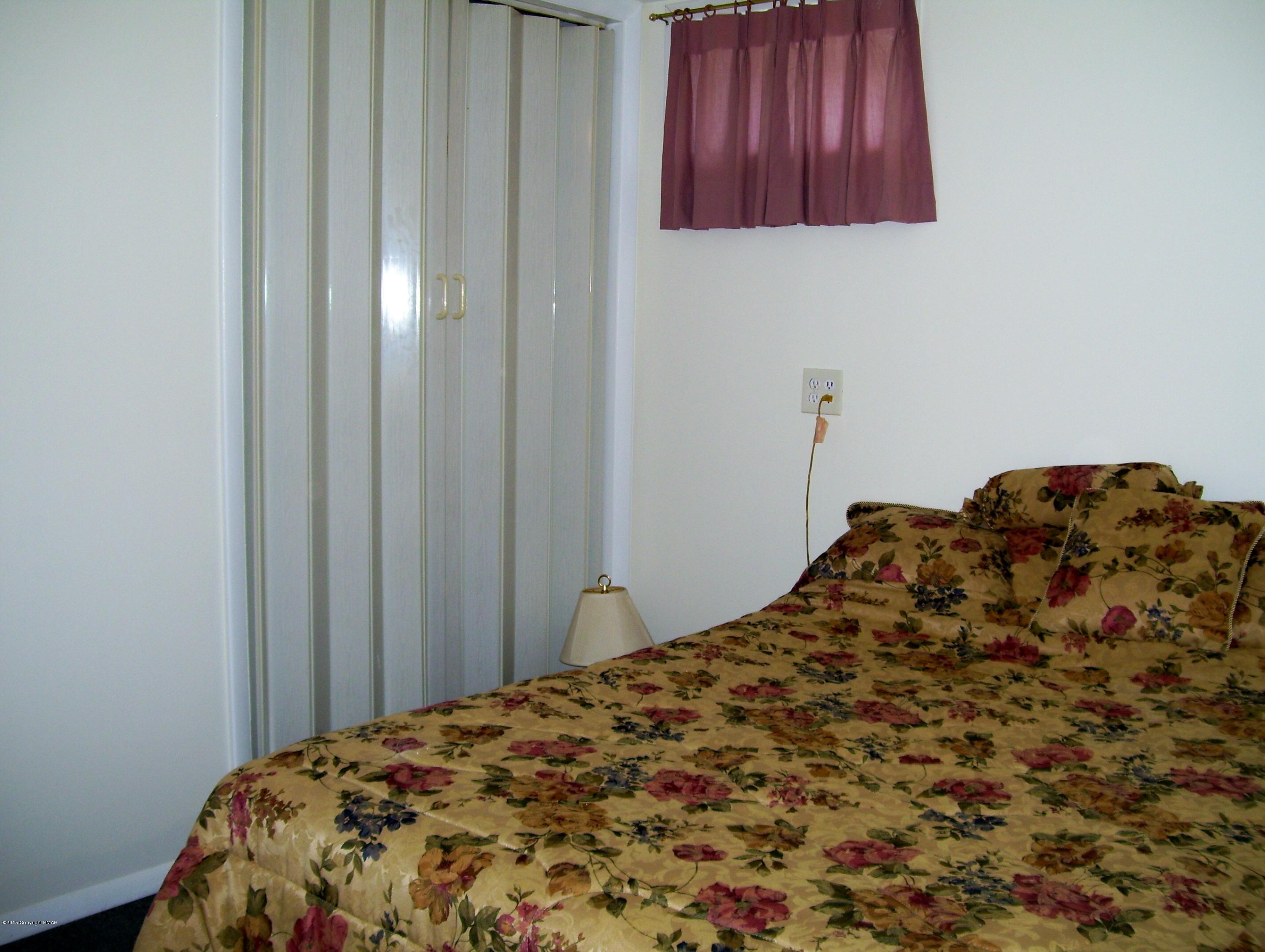 2610 Brookdale Road Scotrun, PA 18355 - Photo 29 of 37 a bedroom with a bed and wooden floor