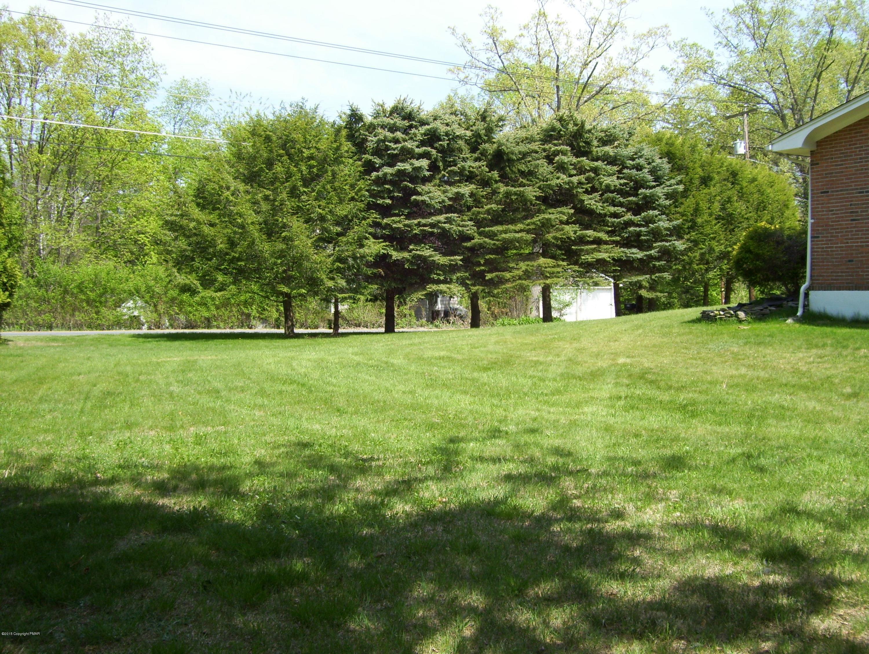 2610 Brookdale Road Scotrun, PA 18355 - Photo 3 of 37 a big yard with lots of green space and house in the back