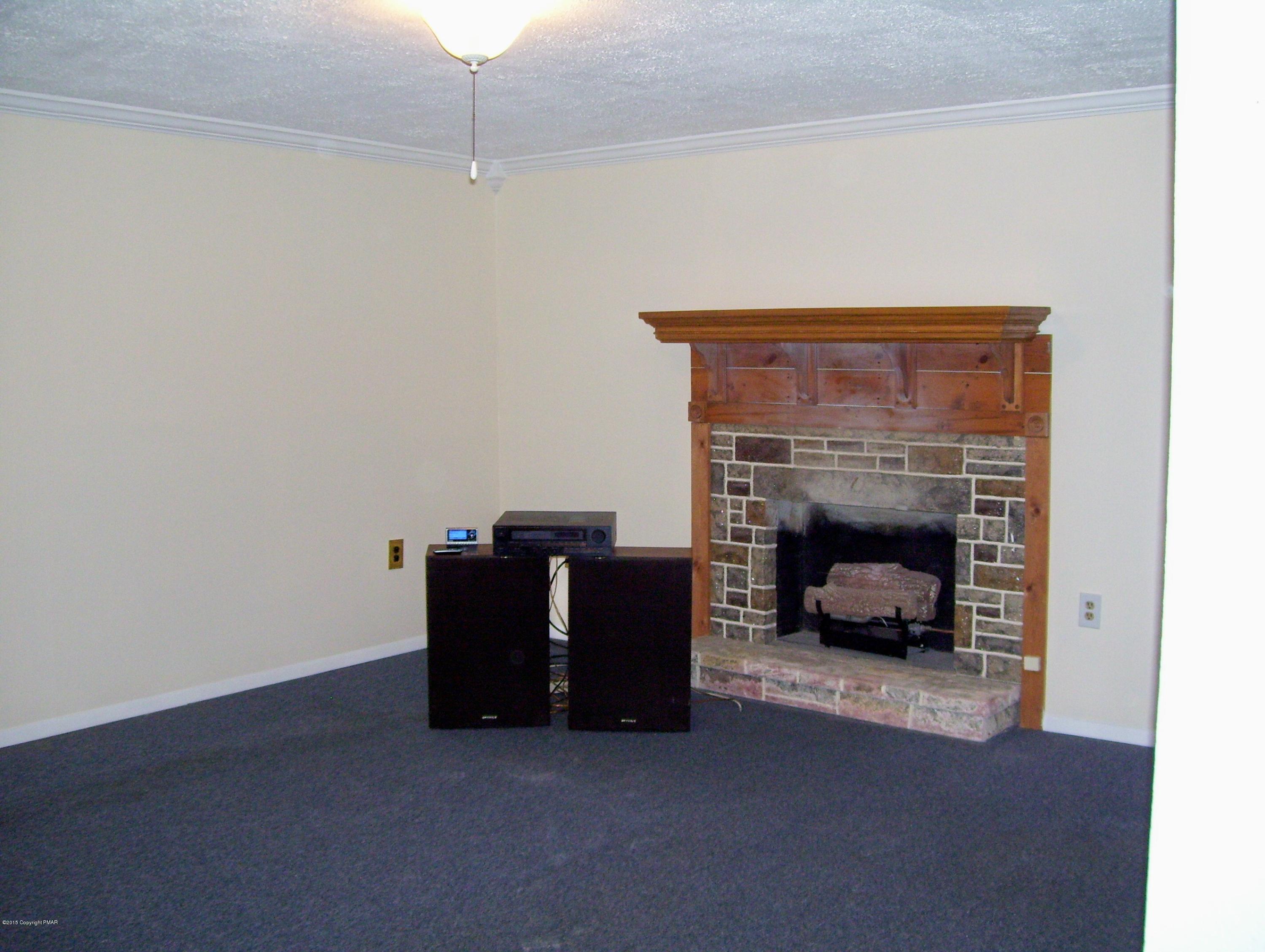 2610 Brookdale Road Scotrun, PA 18355 - Photo 32 of 37 a living room with furniture and a fireplace