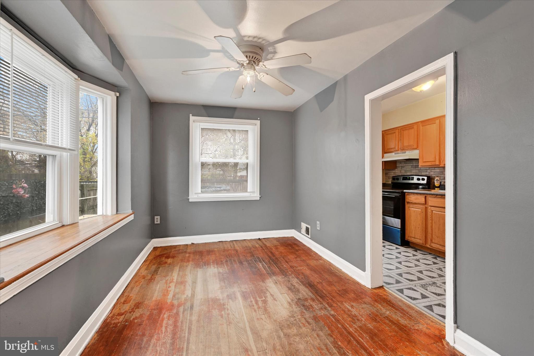 8028 Kavanagh Road Dundalk, MD 21222 - Photo 8 of 29 a view of an empty room with window and wooden floor