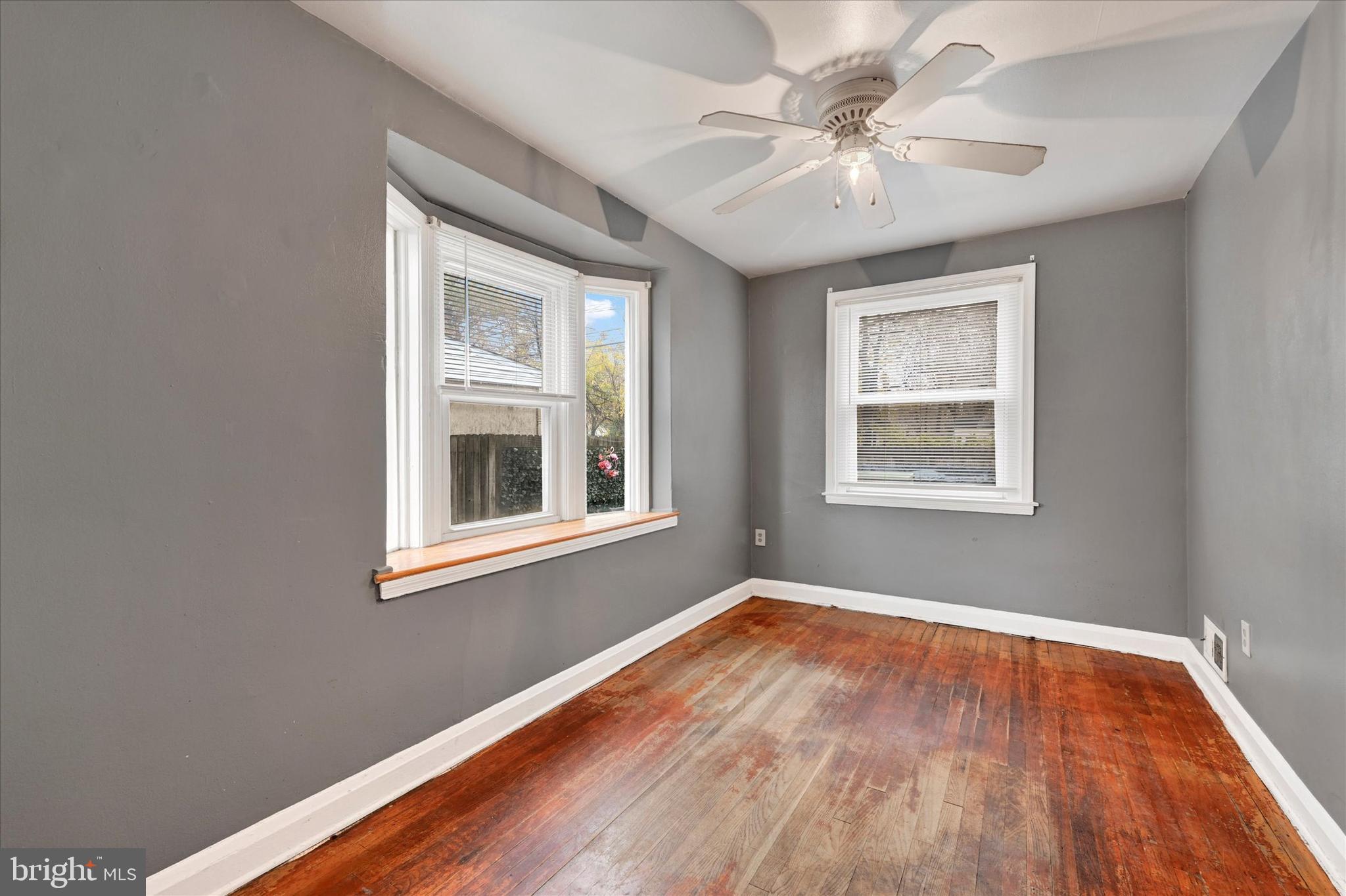 8028 Kavanagh Road Dundalk, MD 21222 - Photo 9 of 29 a view of an empty room with window and wooden floor