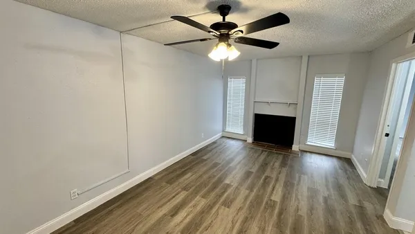 wooden floor in an empty room with a fireplace