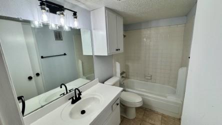 5616 Boca Raton Boulevard, Unit 238 Fort Worth, TX 76112 - Photo 8 of 11 a bathroom with a sink toilet and shower