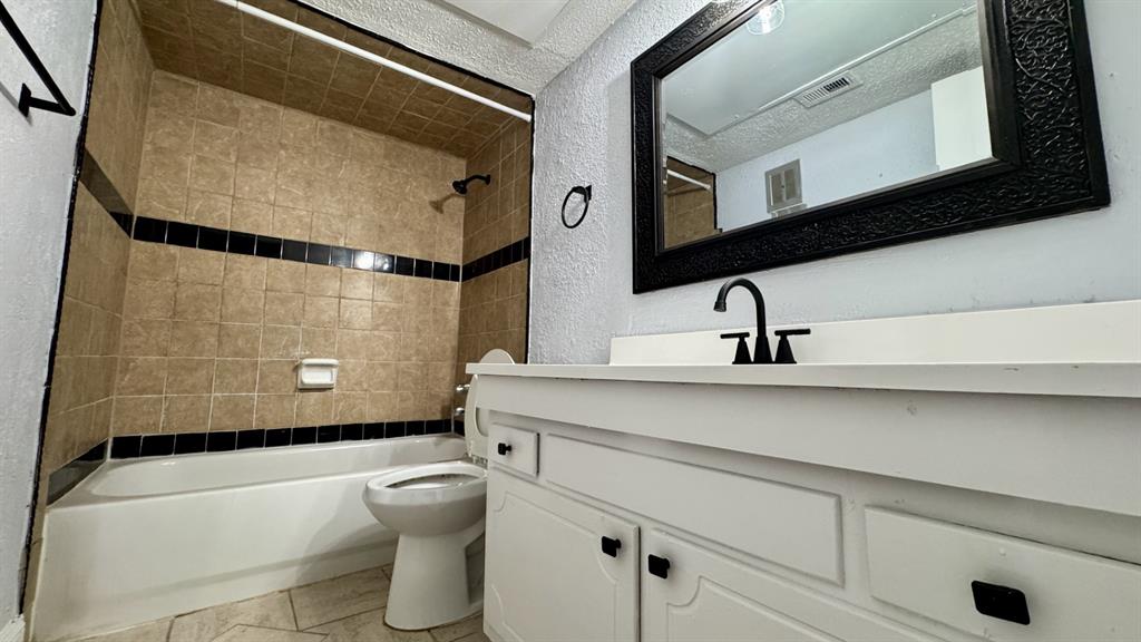 5616 Boca Raton Boulevard, Unit 238 Fort Worth, TX 76112 - Photo 10 of 11 a bathroom with a sink a mirror and a toilet