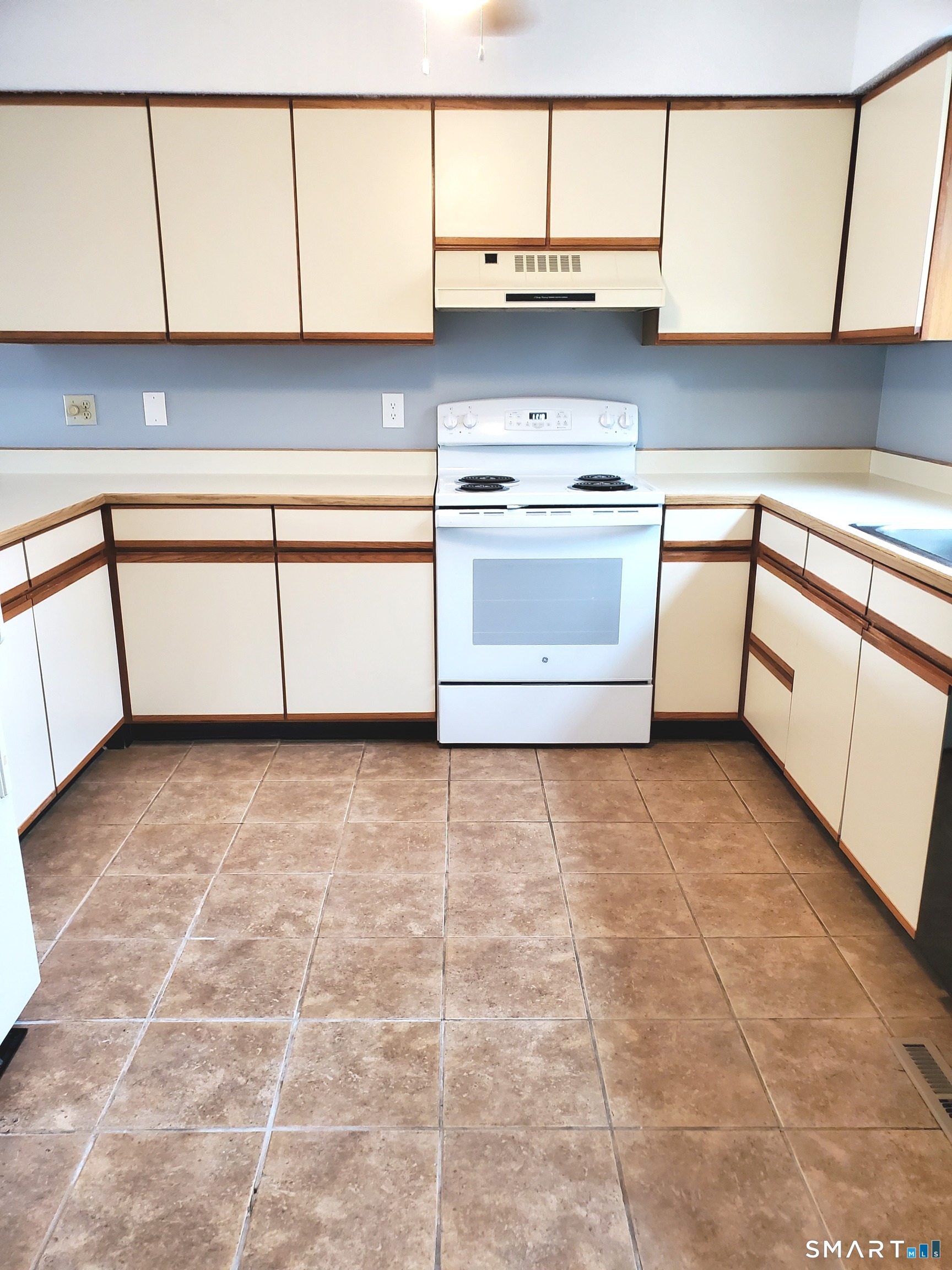 137 Knowles Avenue, Unit 137 Middletown, CT 06457 - Photo 2 of 13 a kitchen with a stove top oven cabinets and a refrigerator