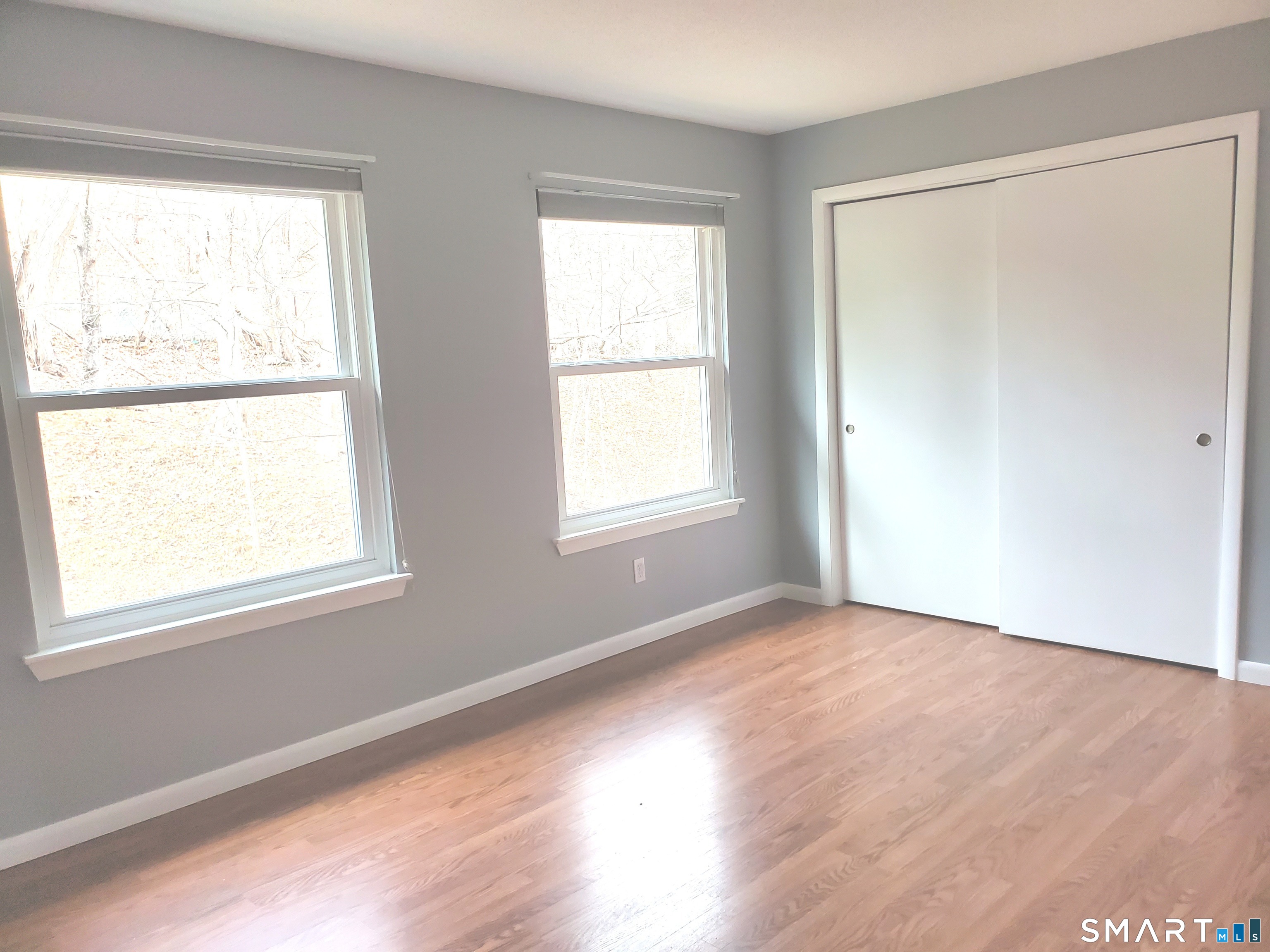 137 Knowles Avenue, Unit 137 Middletown, CT 06457 - Photo 8 of 13 a view of an empty room with wooden floor and a window