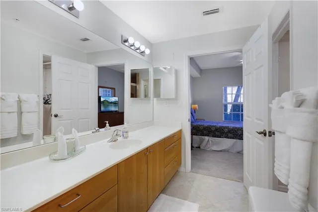a en suite bathroom with a sink and a mirror