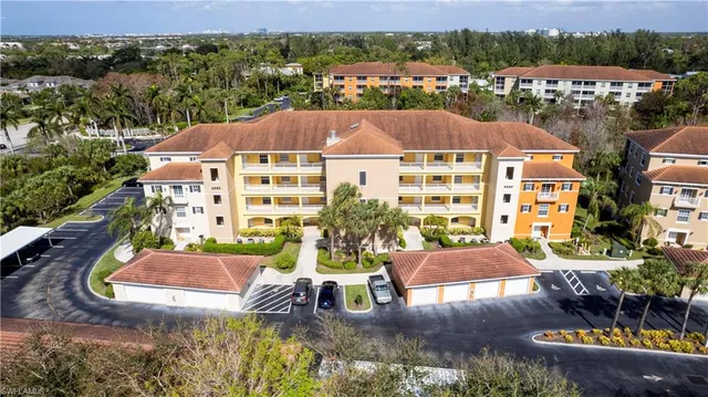 an aerial view of multiple houses with a yard