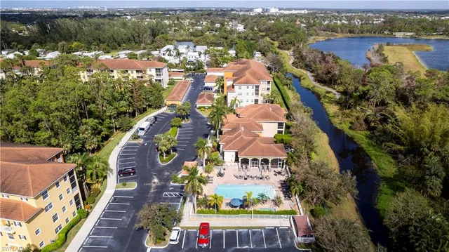 an aerial view of residential houses with outdoor space and river