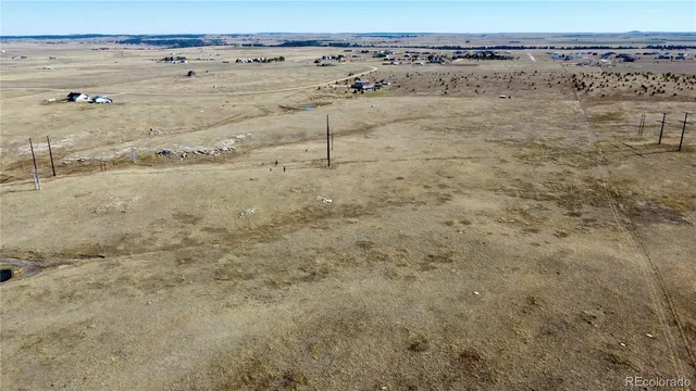 a view of a field with wooden fence