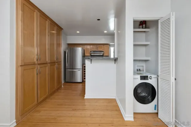 a view of a kitchen with a washer and dryer