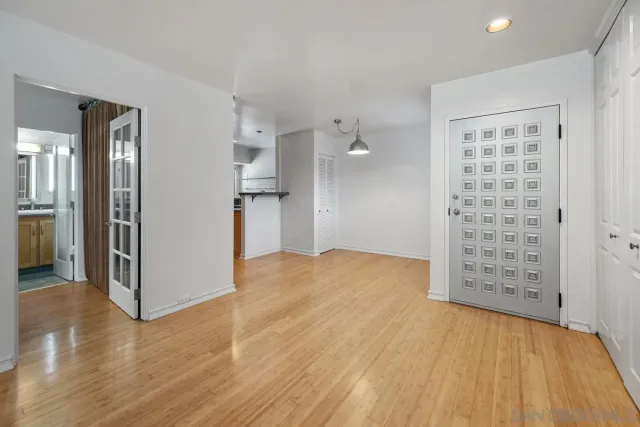 wooden floor in an empty room and kitchen view