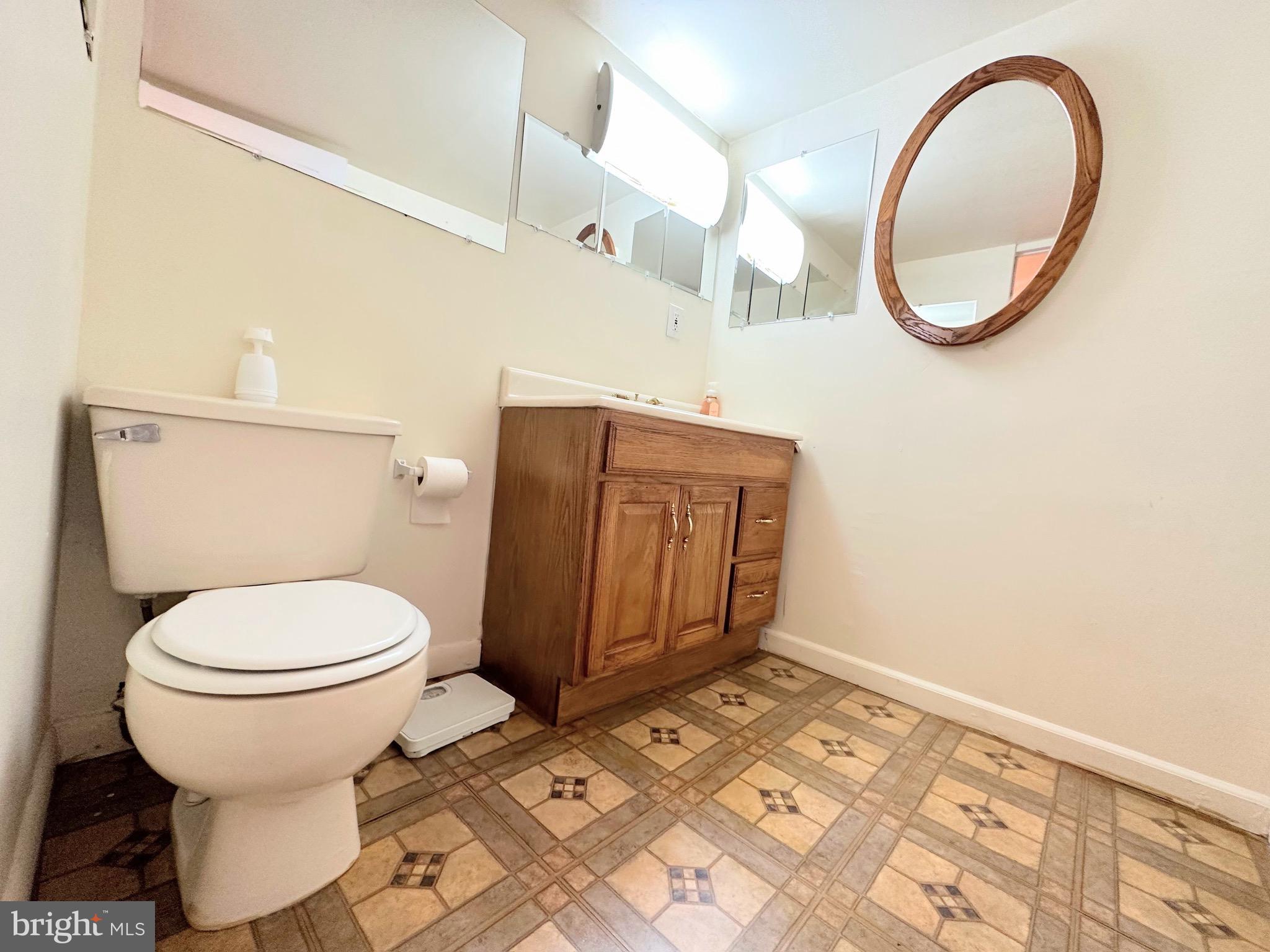 6802 Killarney Street Clinton, MD 20735 - Photo 17 of 19 a bathroom with a toilet and a mirror