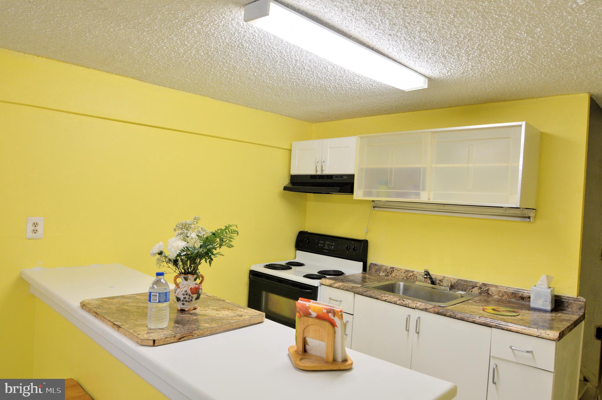 6802 Killarney Street Clinton, MD 20735 - Photo 6 of 19 a kitchen with a sink and cabinets