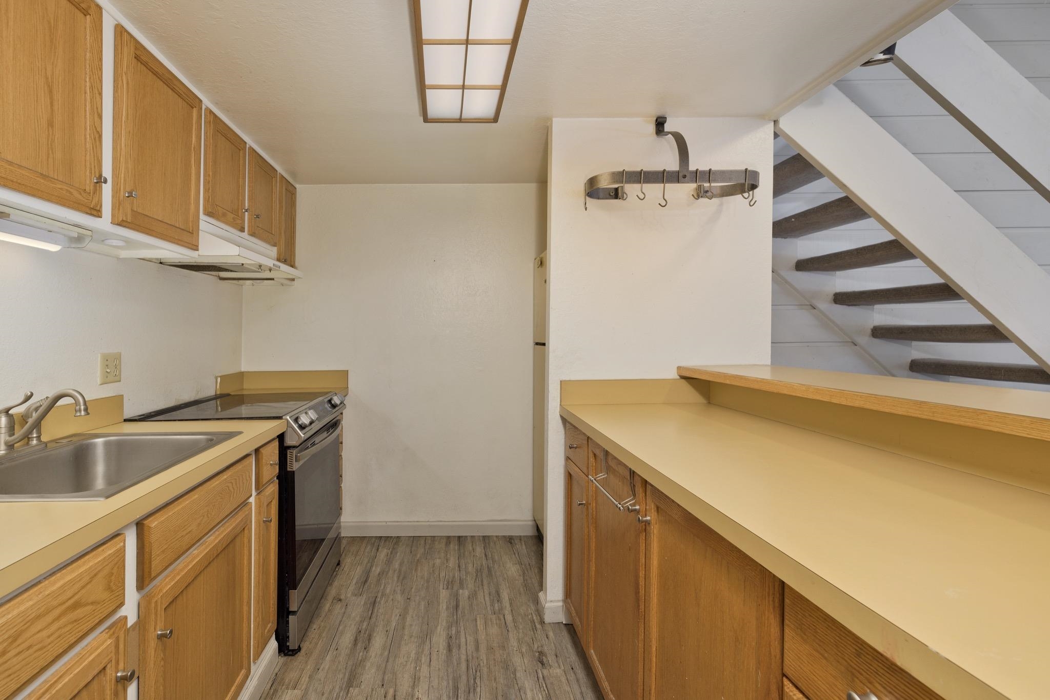 2289 Sierra Nevada Road, Unit G10 Mammoth Lakes, CA 93546 - Photo 6 of 23 Kitchen with stainless steel range with electric cooktop, light countertops, light wood-style flooring, and wood finish cabinets