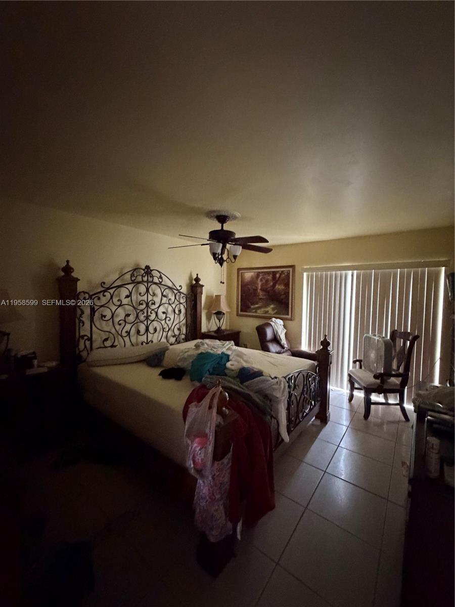 14249 Southwest 103rd Terrace Miami, FL 33186 - Photo 11 of 14 a bedroom with furniture and a chandelier