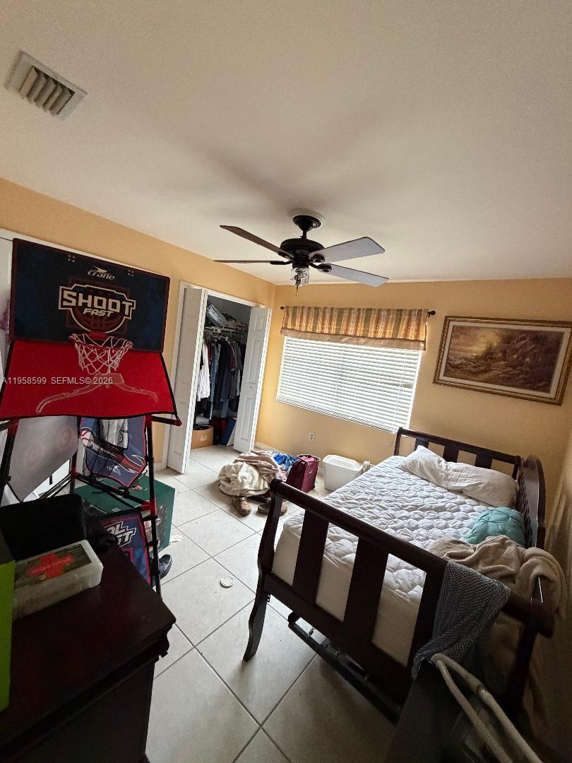 14249 Southwest 103rd Terrace Miami, FL 33186 - Photo 12 of 14 a bedroom with furniture and a chandelier