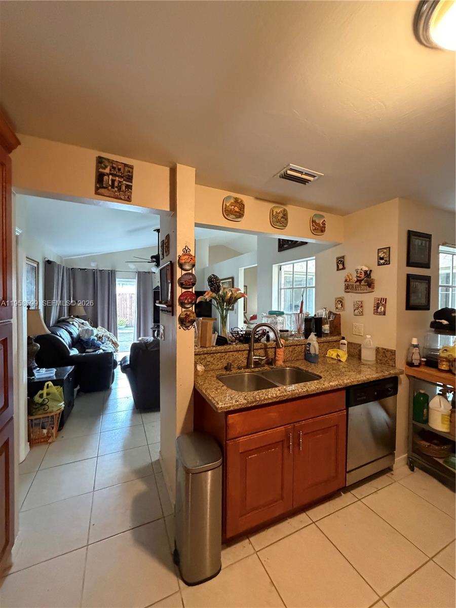14249 Southwest 103rd Terrace Miami, FL 33186 - Photo 10 of 14 a kitchen with stainless steel appliances granite countertop a sink and cabinets
