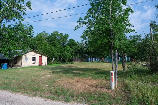 a view of a house with a yard and tree s