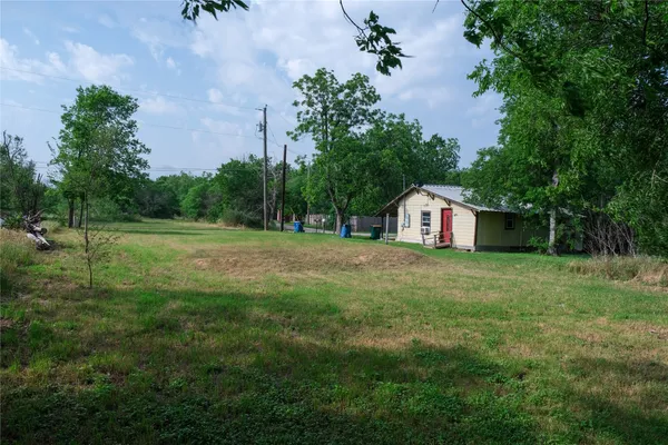 a view of outdoor space with green field and trees all around