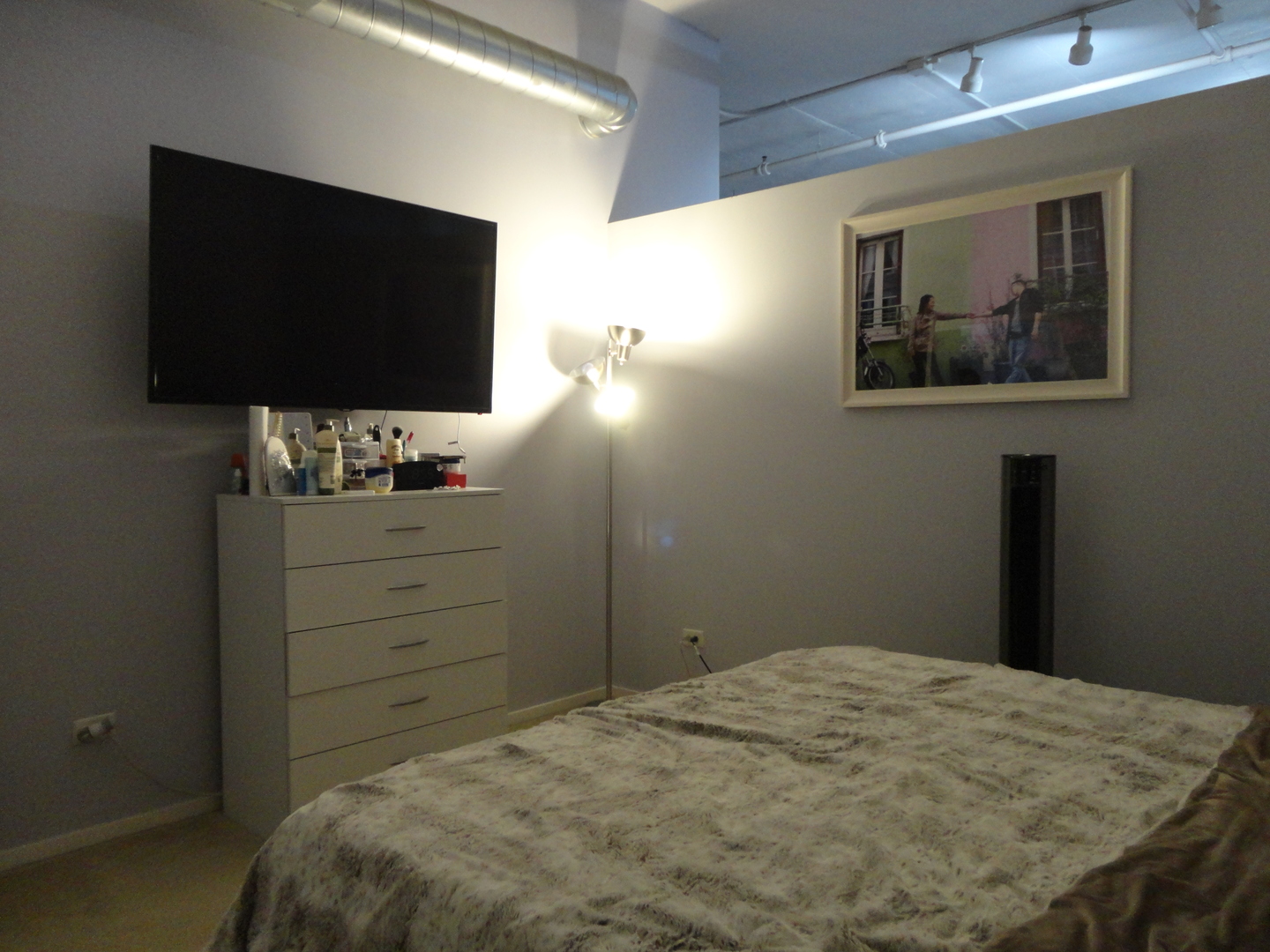 2323 West Pershing Road, Unit 237 Chicago, IL 60609 - Photo 17 of 22 a bedroom with a bed and a flat screen tv