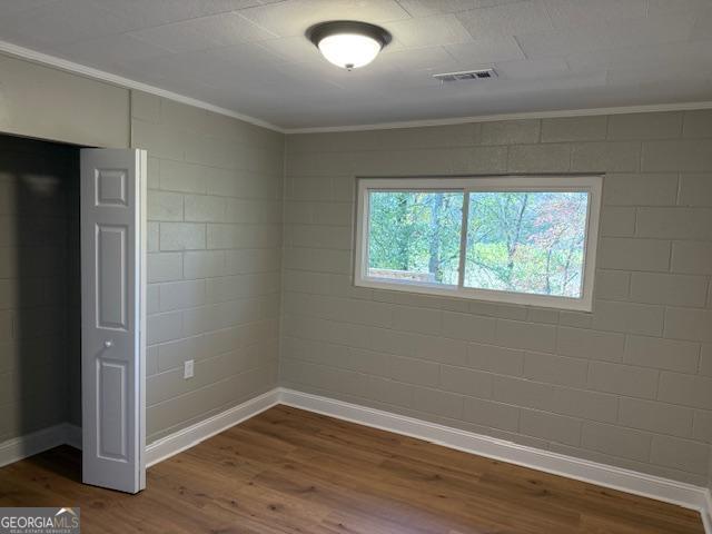 206 Sycamore Way Clarkesville, GA 30523 - Photo 7 of 19 an empty room with wooden floor and windows