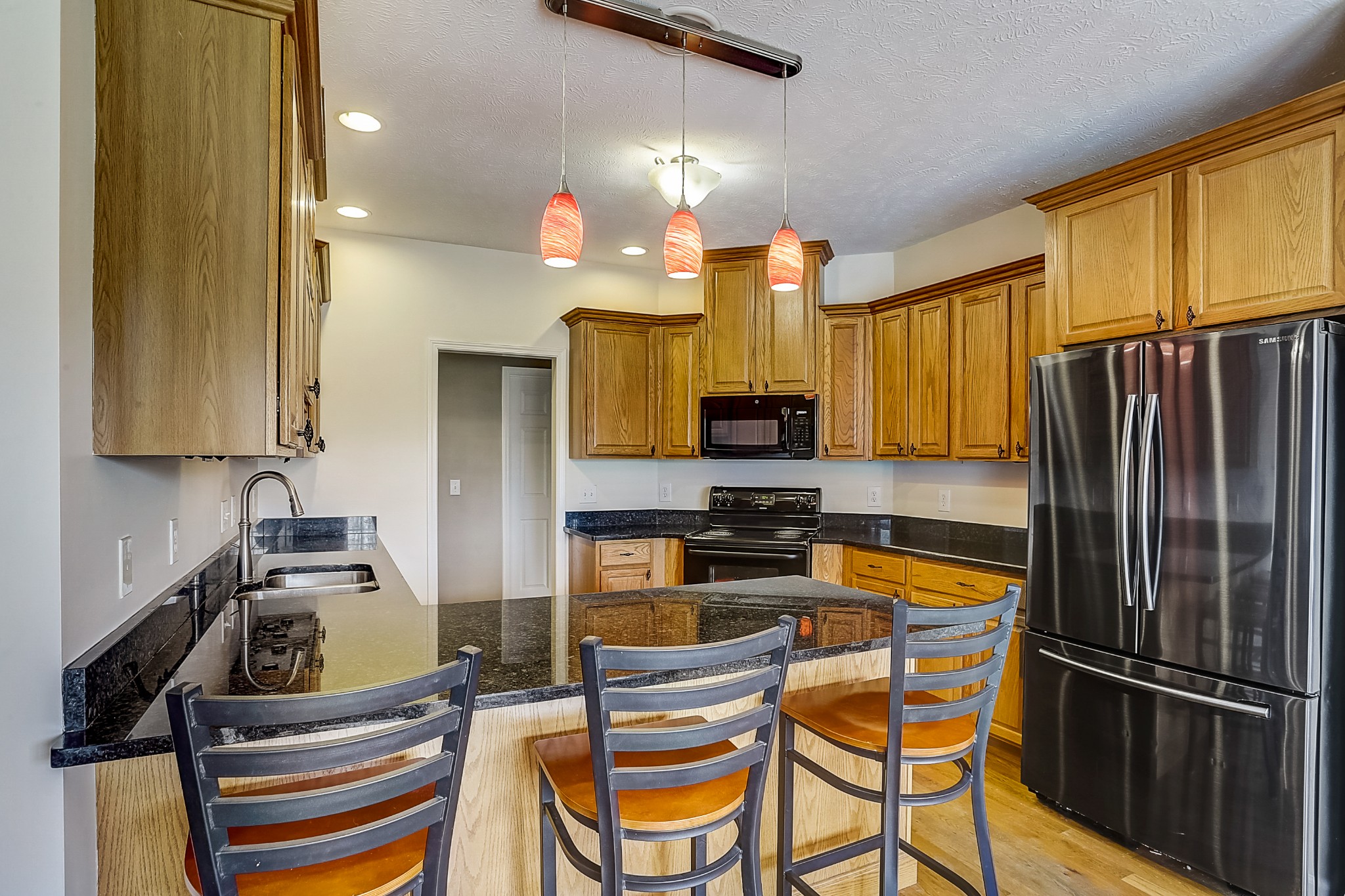 3947 Rowland Road Murfreesboro, TN 37128 - Photo 11 of 50 a kitchen with stainless steel appliances a stove a refrigerator and cabinets