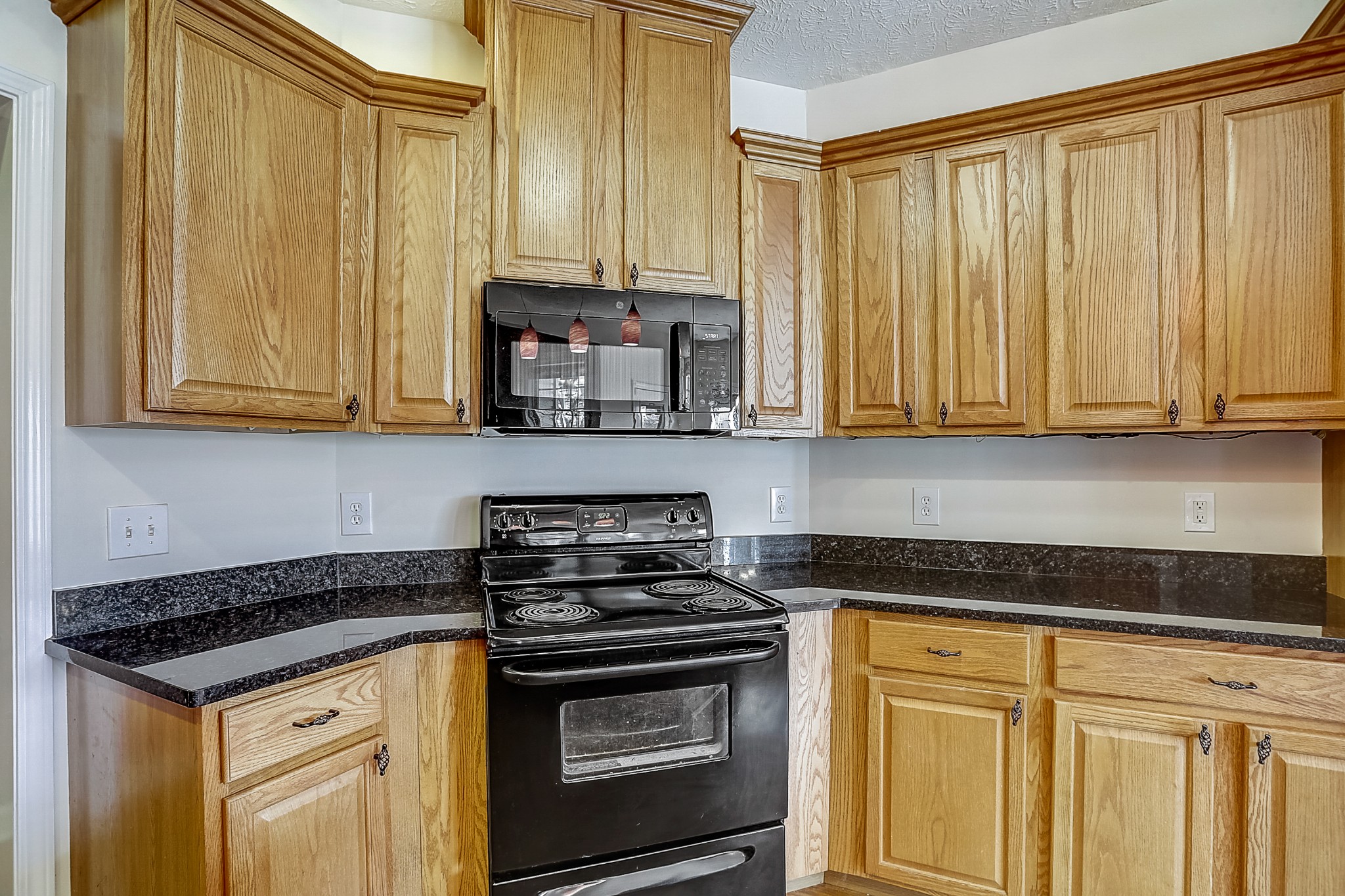 3947 Rowland Road Murfreesboro, TN 37128 - Photo 9 of 50 a kitchen with stainless steel appliances granite countertop white cabinets and a stove top oven