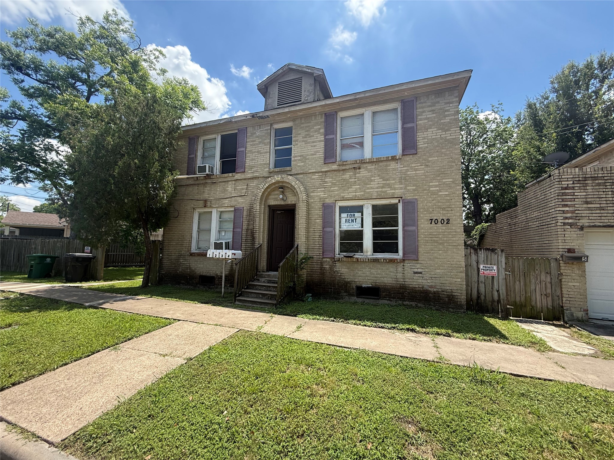 7002 Vandeman Street, Unit 5 Houston, TX 77087 - Photo 1 of 12 a front view of a house with a yard and garage