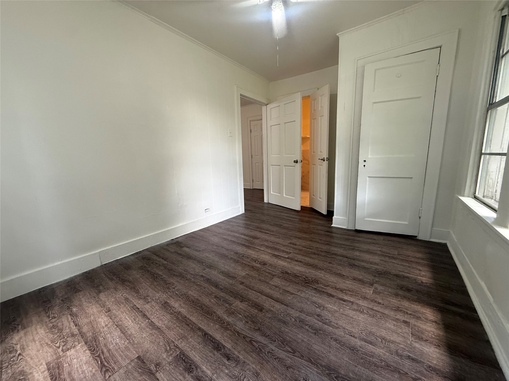 7002 Vandeman Street, Unit 5 Houston, TX 77087 - Photo 12 of 12 an empty room with wooden floor and windows