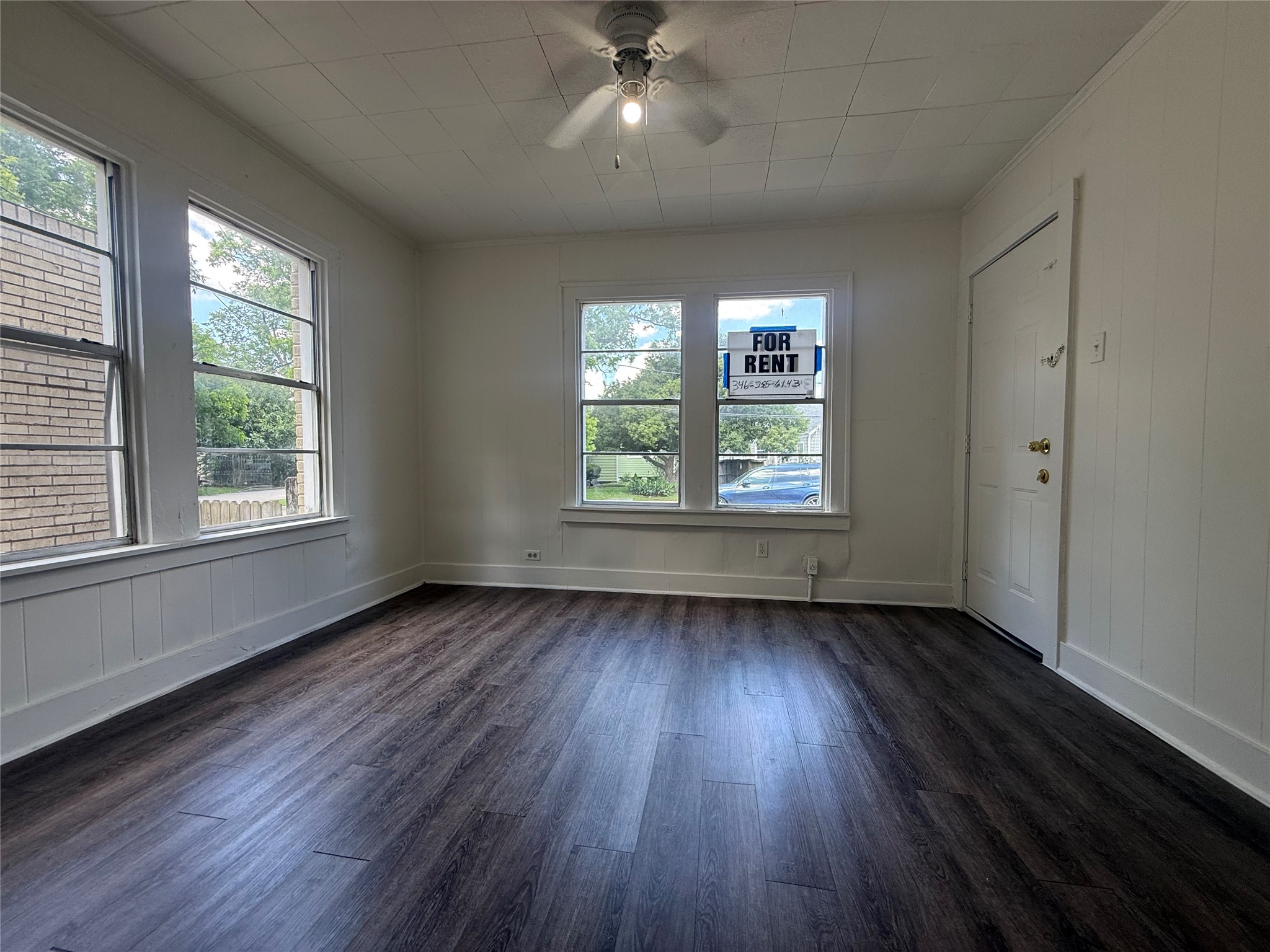 7002 Vandeman Street, Unit 5 Houston, TX 77087 - Photo 3 of 12 an empty room with wooden floor and windows