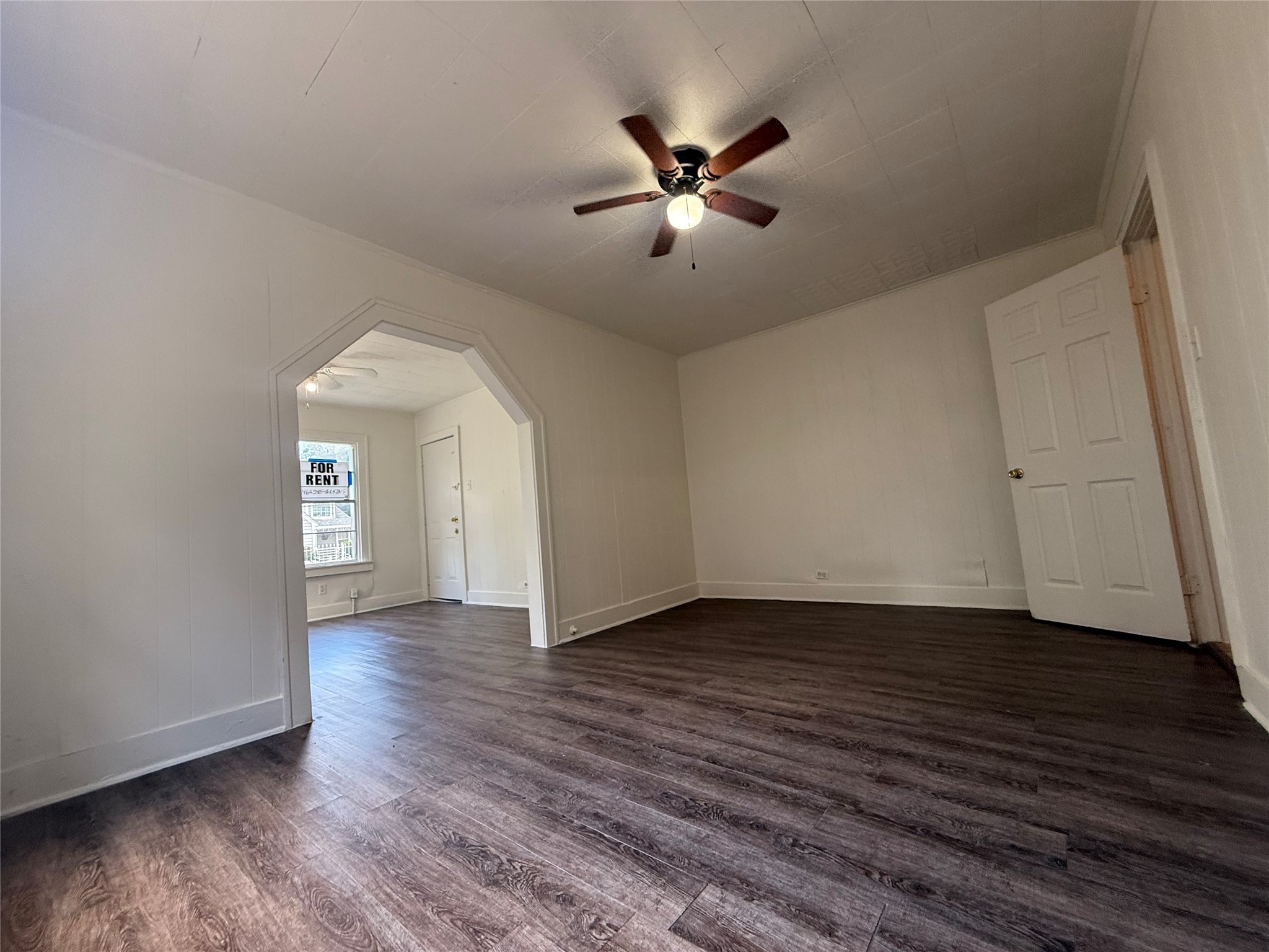 7002 Vandeman Street, Unit 5 Houston, TX 77087 - Photo 4 of 12 a view of an empty room with wooden floor and a window