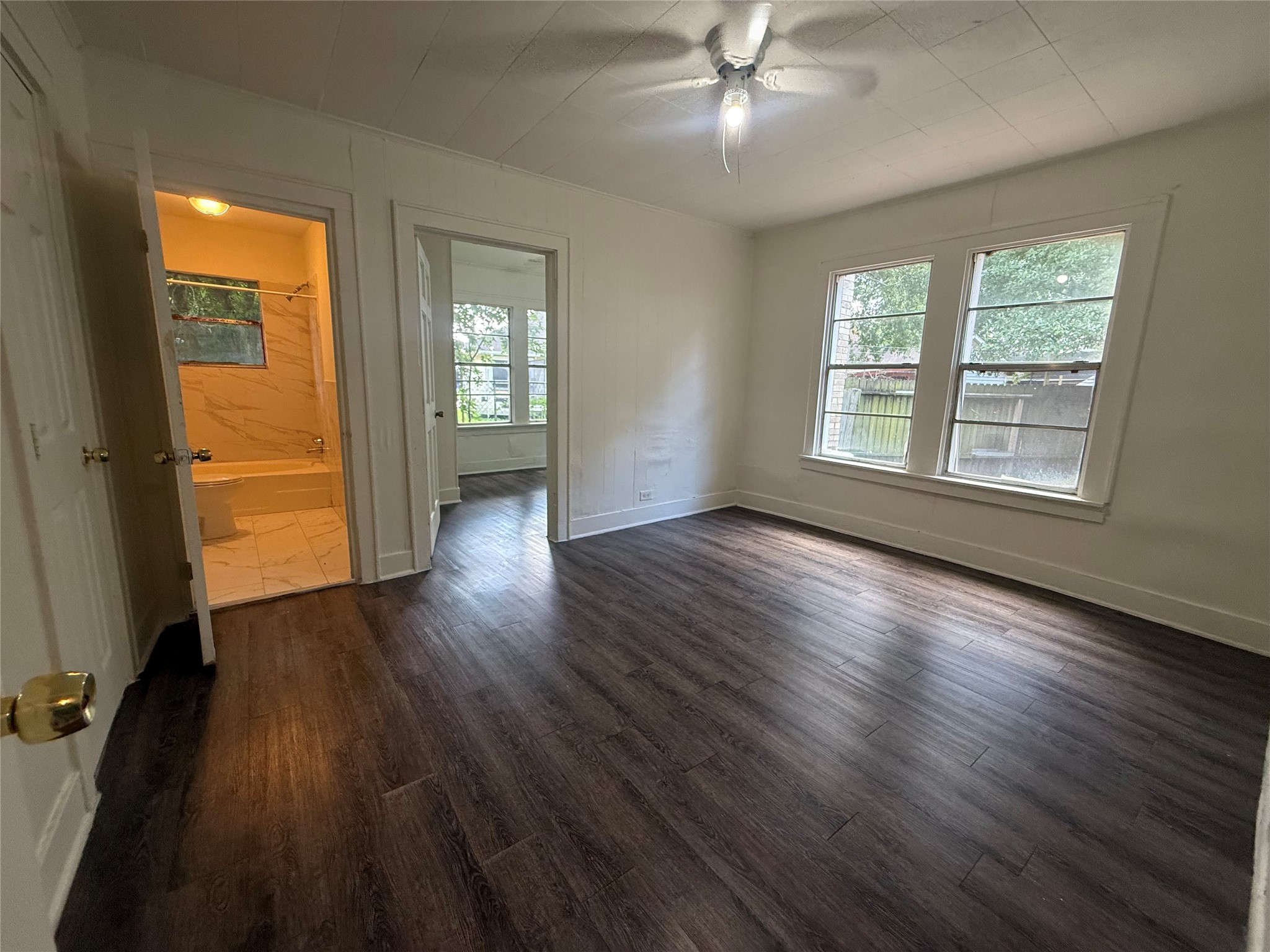 7002 Vandeman Street, Unit 5 Houston, TX 77087 - Photo 6 of 12 a view of an empty room with wooden floor and a window