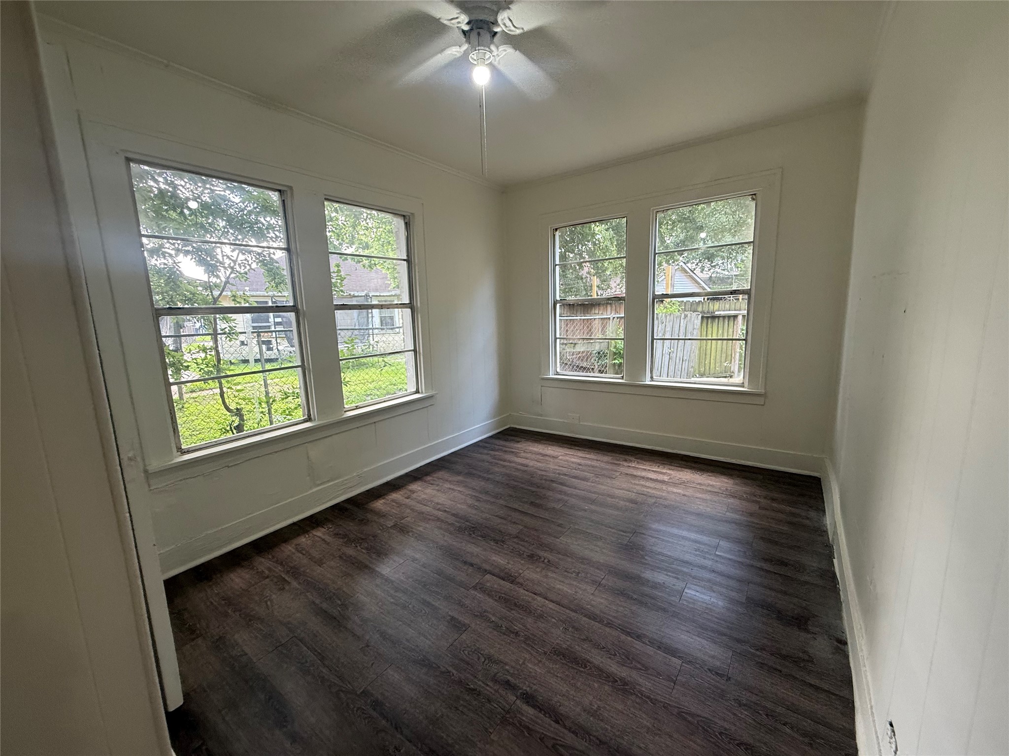 7002 Vandeman Street, Unit 5 Houston, TX 77087 - Photo 7 of 12 a view of an empty room with wooden floor and a window