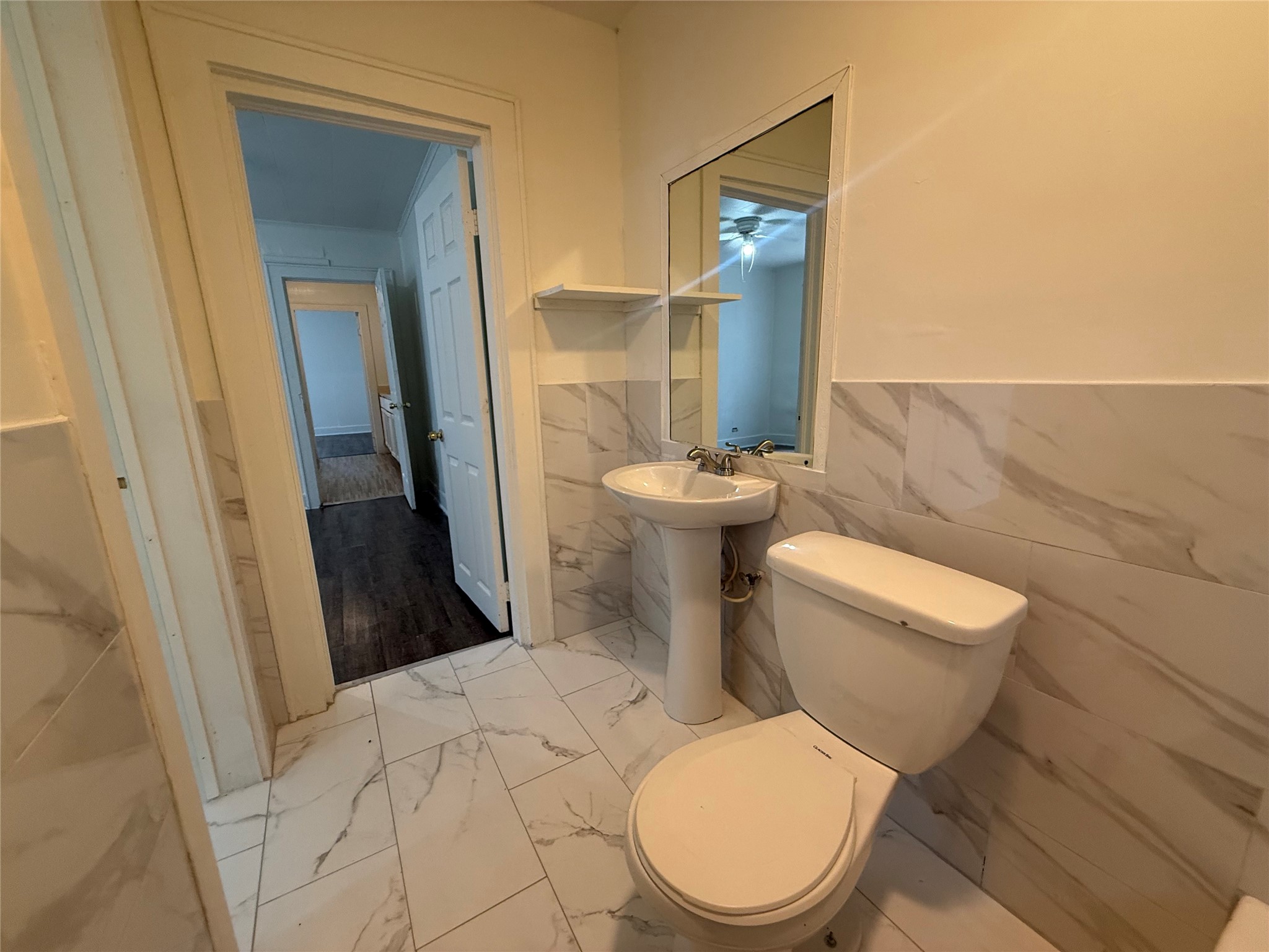 7002 Vandeman Street, Unit 5 Houston, TX 77087 - Photo 8 of 12 a white toilet sitting next to a bathroom sink