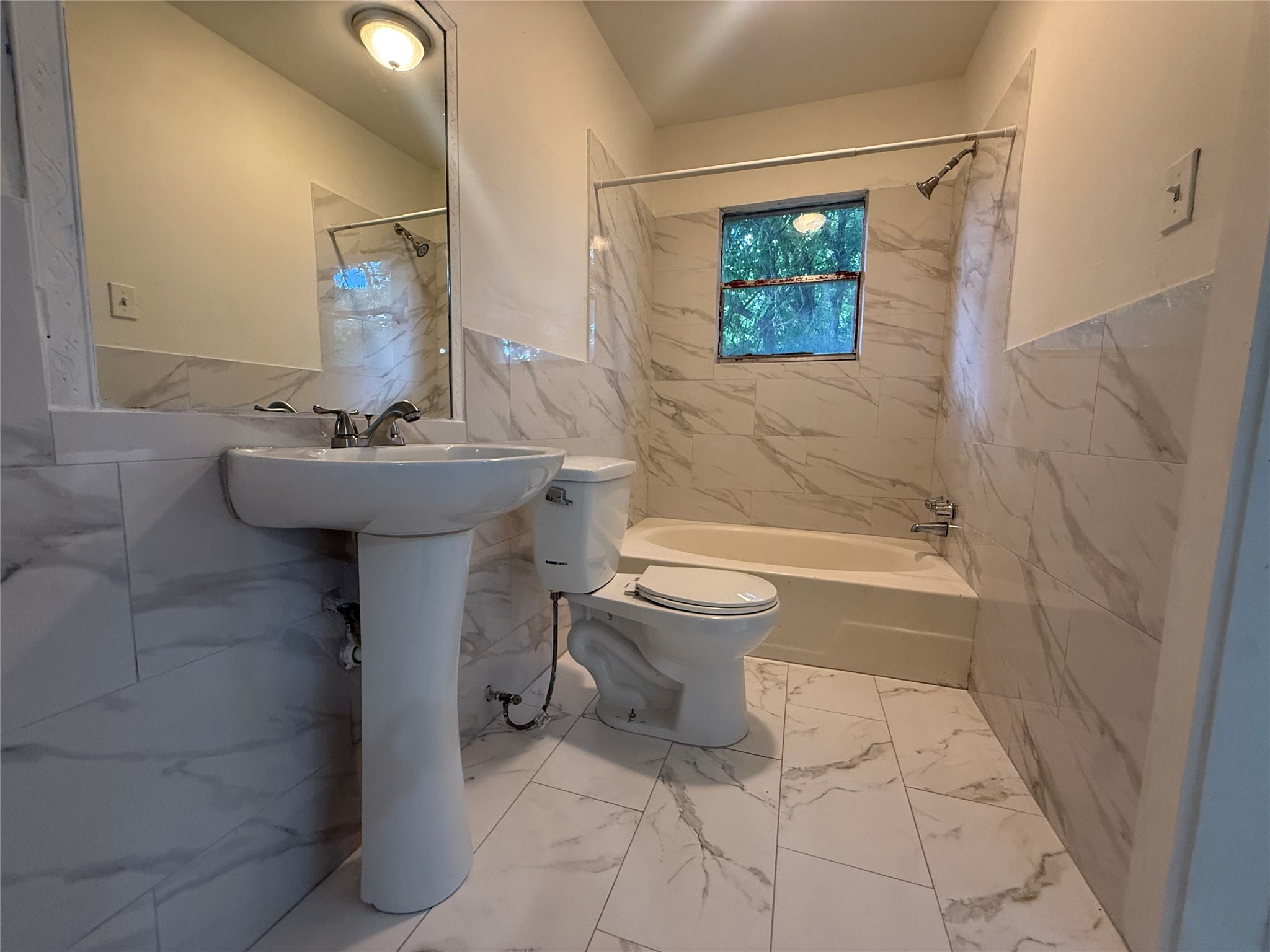 7002 Vandeman Street, Unit 5 Houston, TX 77087 - Photo 9 of 12 a bathroom with a sink toilet and shower