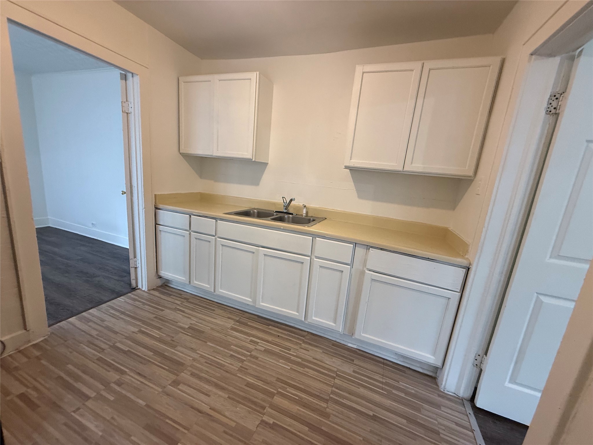 7002 Vandeman Street, Unit 5 Houston, TX 77087 - Photo 10 of 12 a kitchen with a sink a window and cabinets