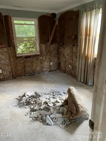 a view of a livingroom with wooden floor and a window