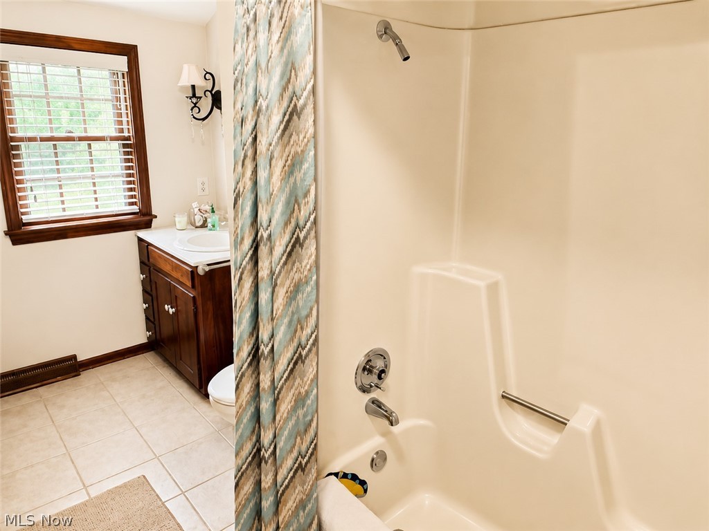6155 Gibson Road Canfield, OH 44406 - Photo 34 of 43 Bathroom featuring a white integrated tub and shower unit with a grab bar