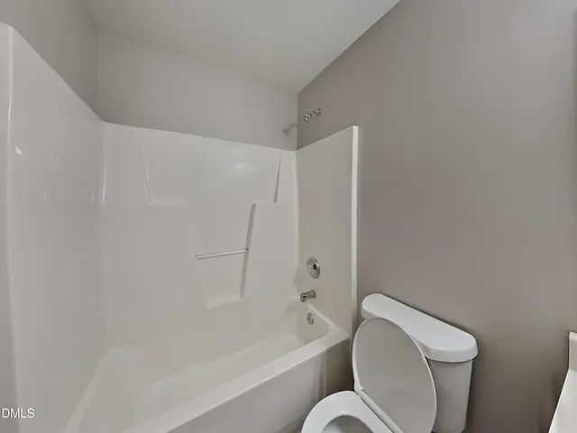 a bathroom with a toilet and a bathtub