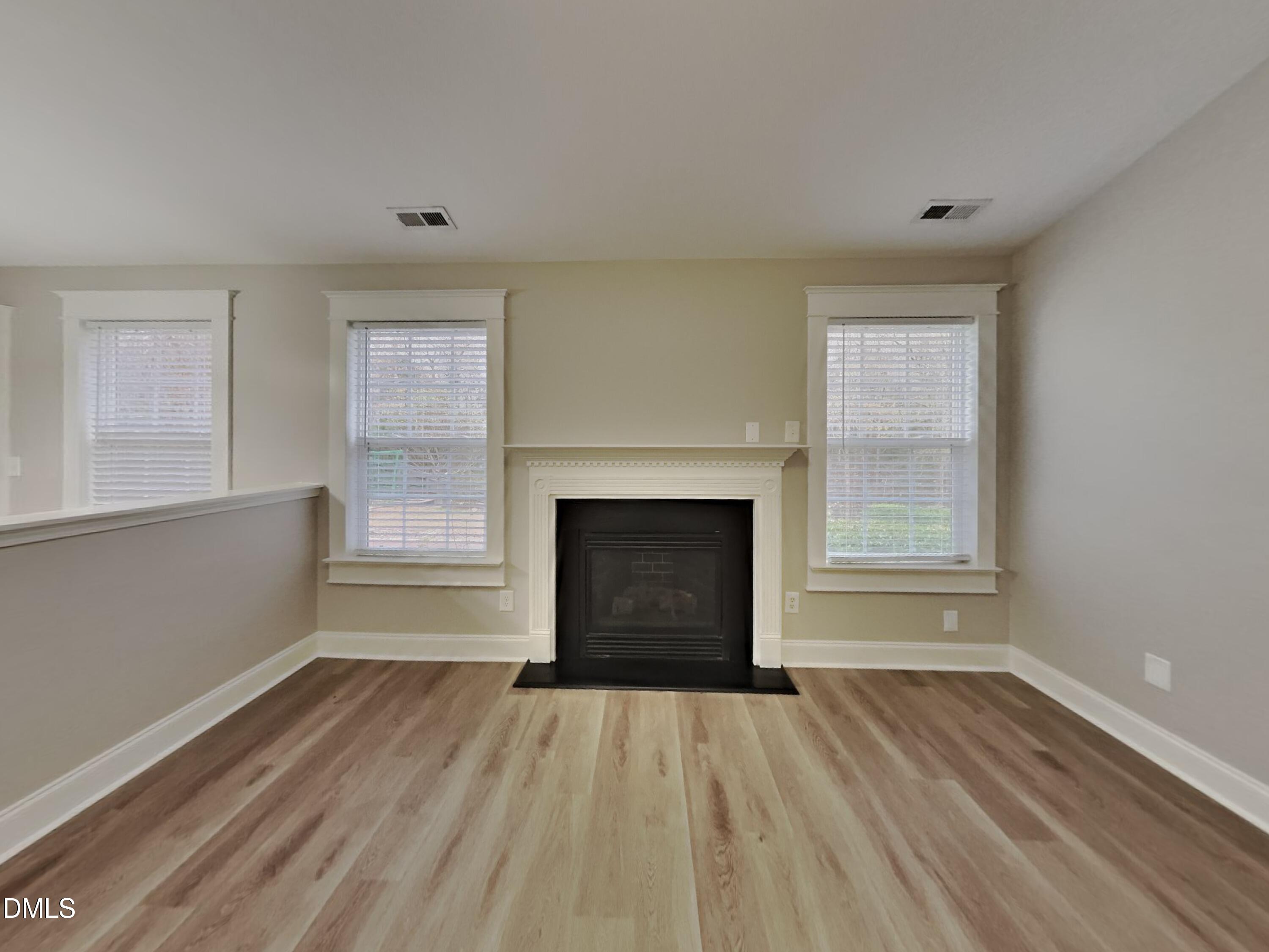 3665 Watkins Ridge Court Raleigh, NC 27616 - Photo 3 of 15 a view of empty room with wooden floor and fireplace